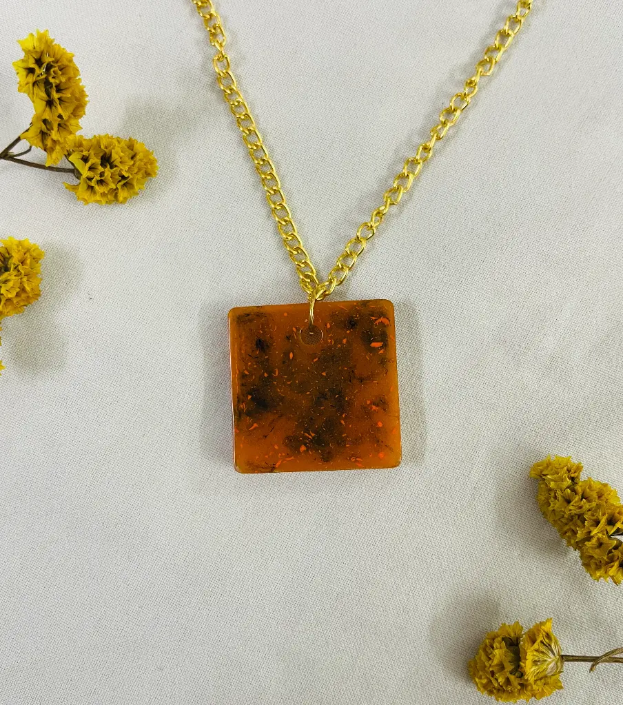 An orange with black ink Locket -GML022